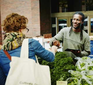 a man selling vegetables on the market