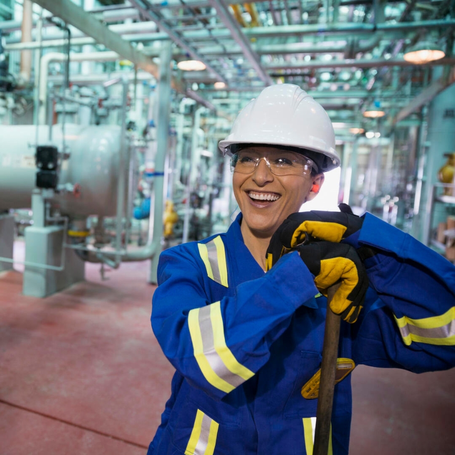 cheerful female worker in gas plant