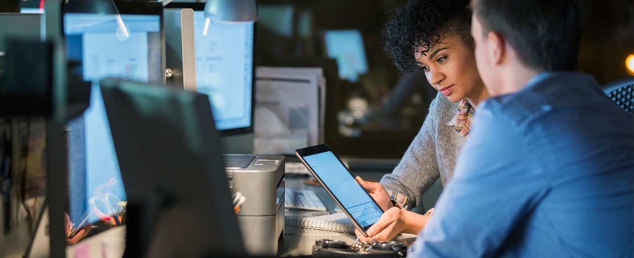 People working by the desk with tablet